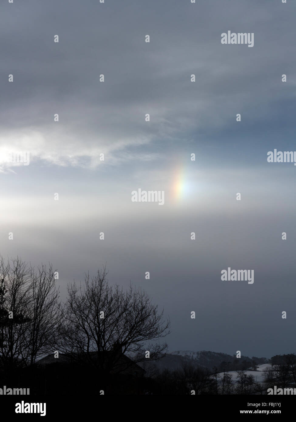 Fragment of a rain halo around the sun on a wintery snowy day in Cumbria England Stock Photo