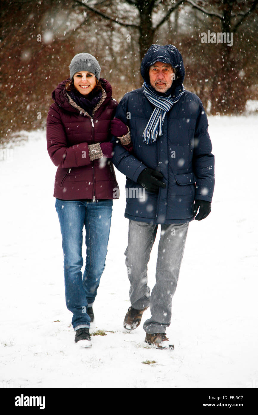 Senior, man, young woman, full length, walk, winter Stock Photo