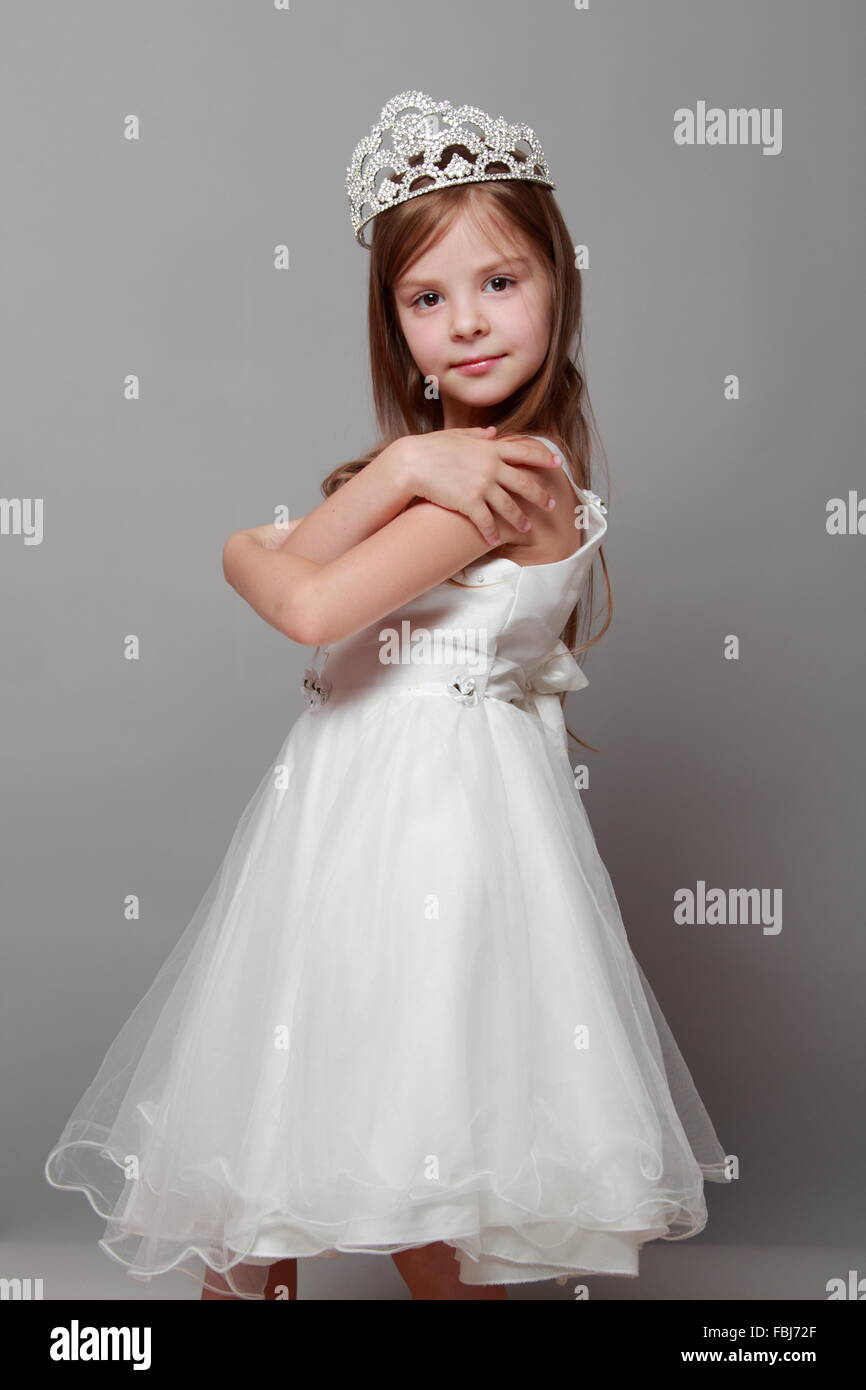 Beautiful Little Girl In Princess Dress With Long Hair On Grey