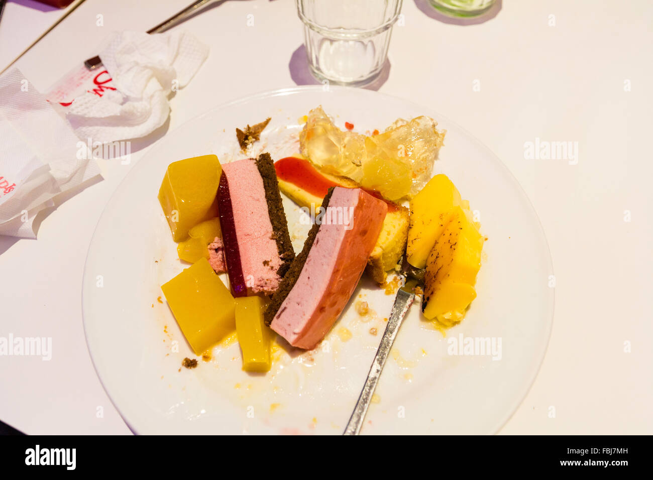 Japan. 'Sweet Paradise' Japanese famous all-you-can-eat cake and sweet restaurant. Plate, with folk, full of various deserts and cakes on table. Stock Photo