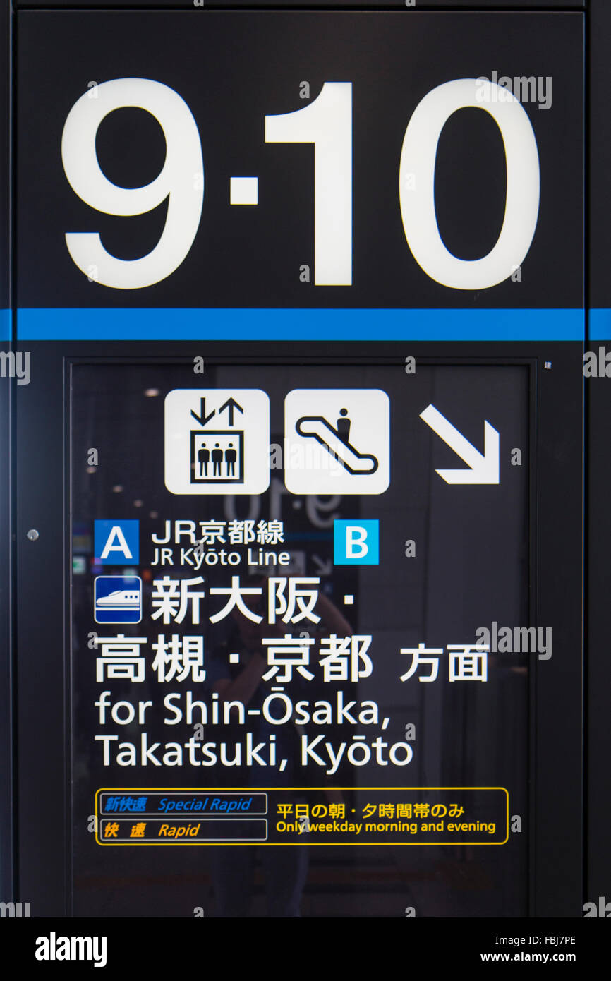 Osaka station sign for platforms 9 and 10. JR Kyoto line, destinations Shin-Osaka, Takatsuki and Kyoto. Icon for lift and stairs. In English and Kanji. Stock Photo