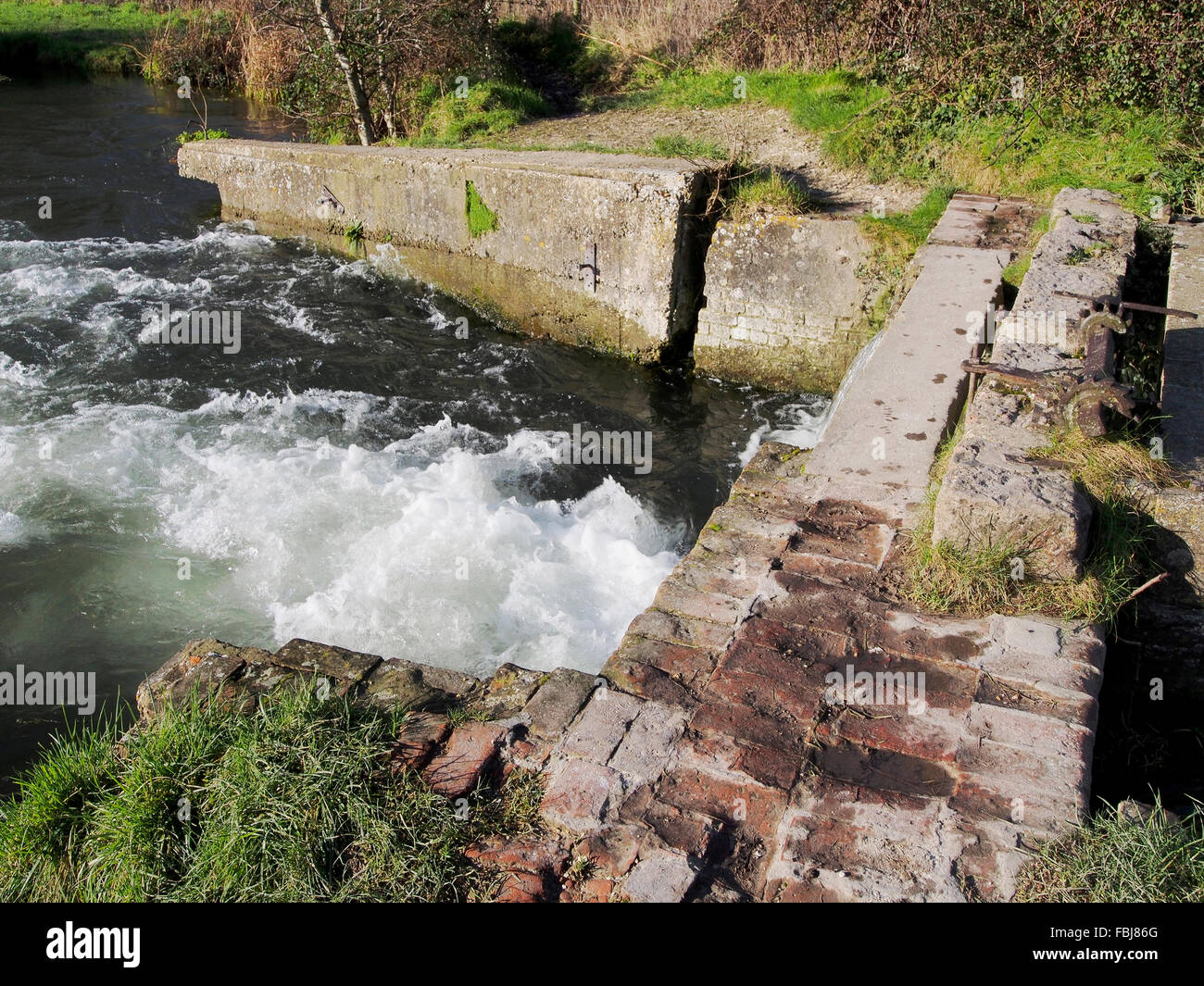 The old Compton lock, now a weir on the Itchen Navigation at Shawford, Winchester is on the Itchen Way footpath. Stock Photo