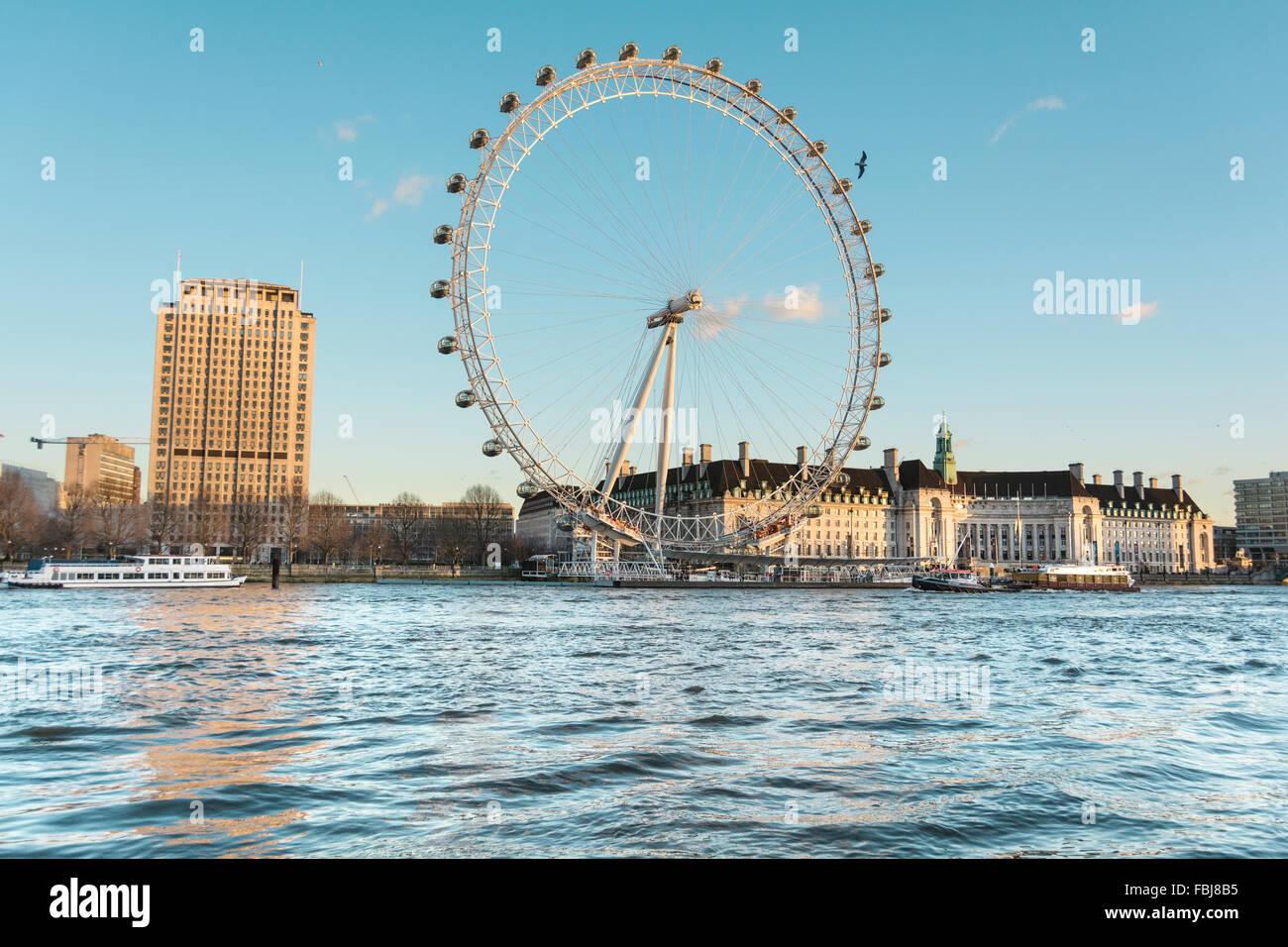 Evening twilight reflects on the Shell Centre, London Eye and City Hall on the South Bank of the River Thames, London, UK. Stock Photo