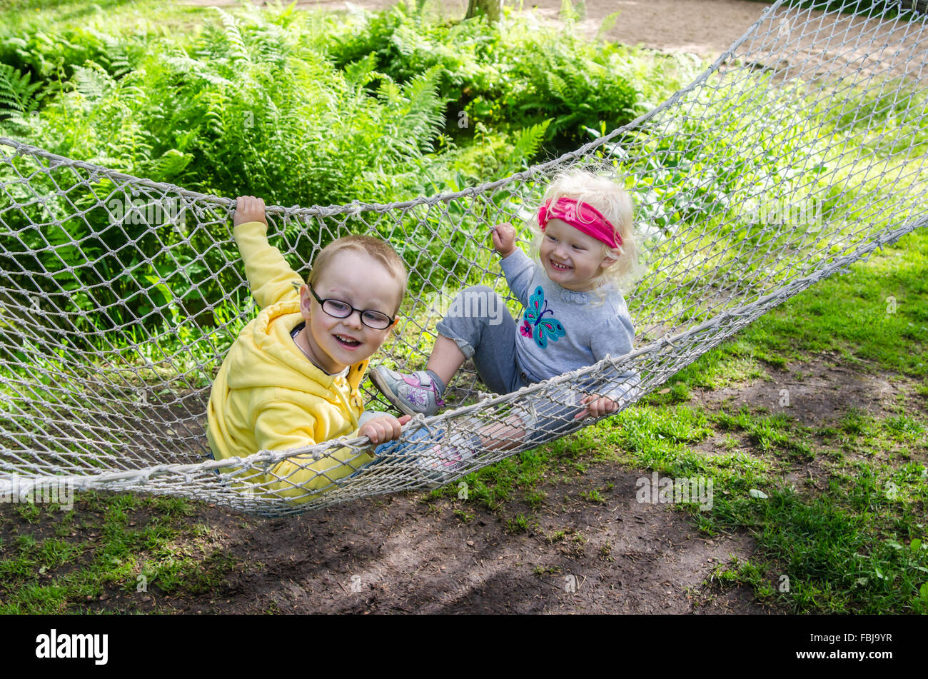 Children swinging in a hammock Stock Photo