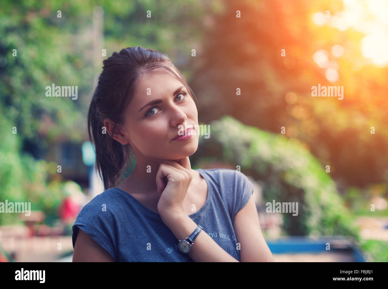 Portrait of a beautiful young woman in park. Stock Photo