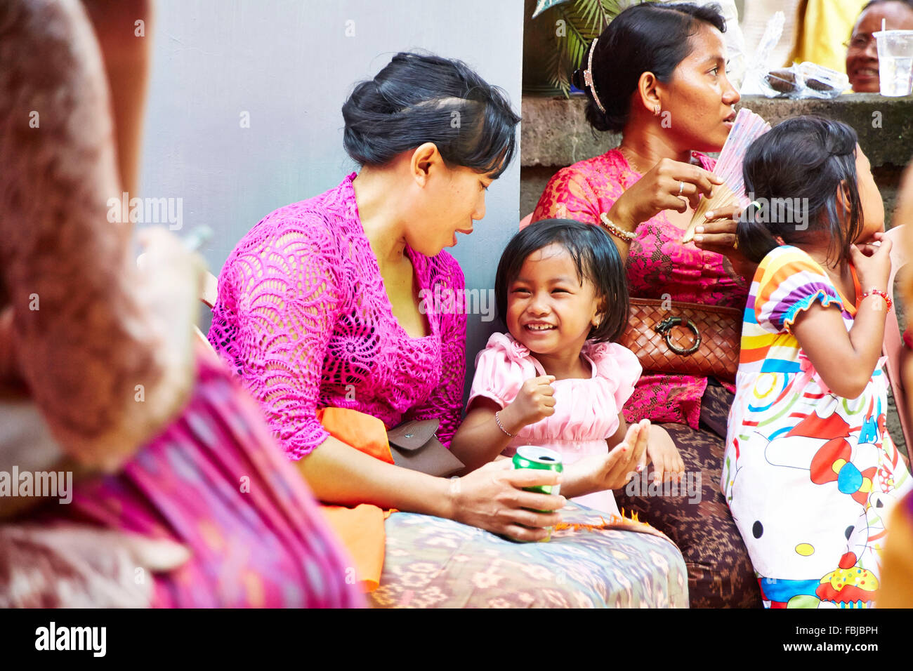Mother playing with daughter, little girl laughing, reportage, traditional wedding, Bali, Indonesia, Asia Stock Photo