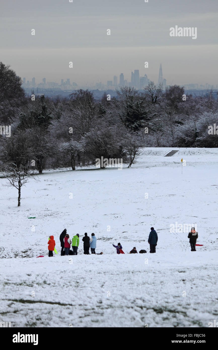 Epsom Downs, Surrey, UK. 17th January 2016. Overnight snowfall left a blanket of white across Epsom Downs which remained throughout the day. As part of the North Downs in Surrey, Epsom Downs is at a slightly higher elevation than the surrounding area and often has a covering when the nearby town is snow free. The city of London about 15 miles away, is visible in the distance. Stock Photo