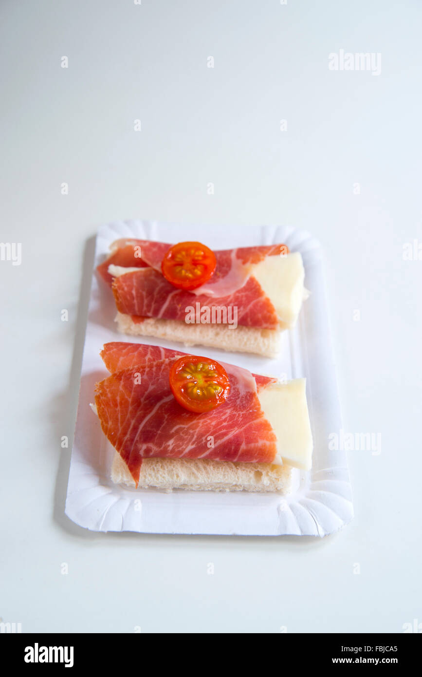 Spanish tapas Wrapped cheese with Iberian ham on sliced bread with