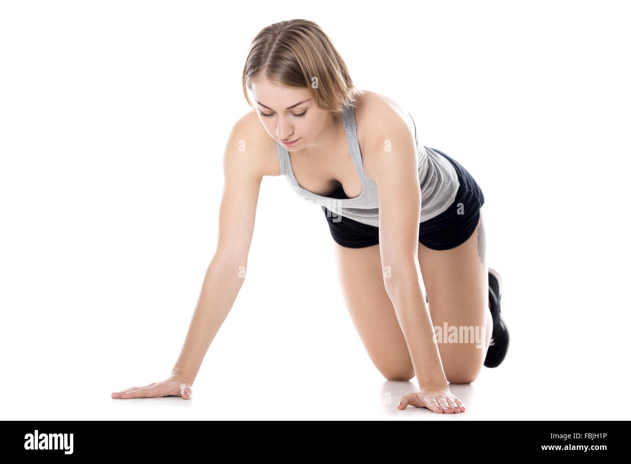 Portrait of young slim beautiful woman doing fitness exercises on mat, warming up, preparation for push-ups, table pose Stock Photo