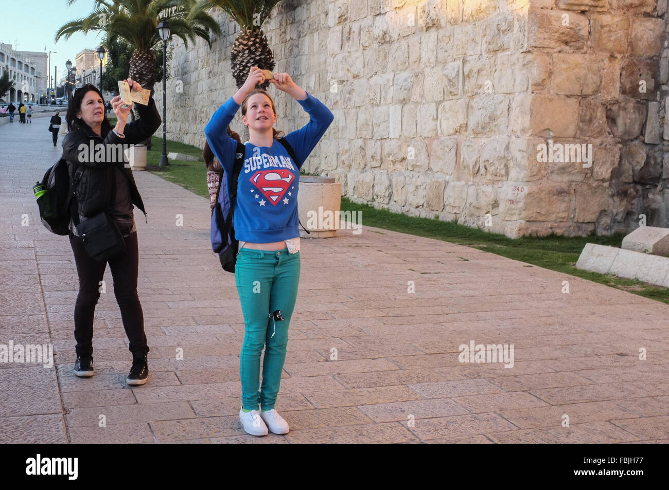 Jerusalem, Israel. 17th January, 2016. Two women take smartphone photos of Jerusalem's Old City walls near the Jaffa Gate. Credit:  Nir Alon/Alamy Live News Stock Photo