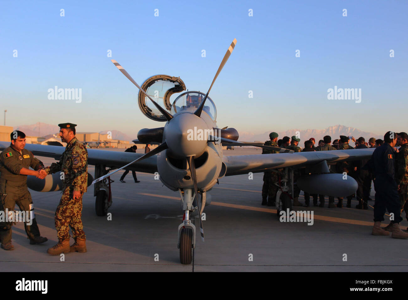 KABUL AFGFHANISTAN,JAN 15,2016  Afghan National Army Officials stand near to A-29 Super Tucano aircrafts during a ceremony in Kabul, Afghanistan on Friday January 15, 2016. U.S officials formally delivered four Brazil-made Super Tucano attack aircraft to the Afghan defense ministry on Friday in an effort to help embattled Afghan security forces carry out their counter-insurgency missions in the volatile country in days to come. Stock Photo