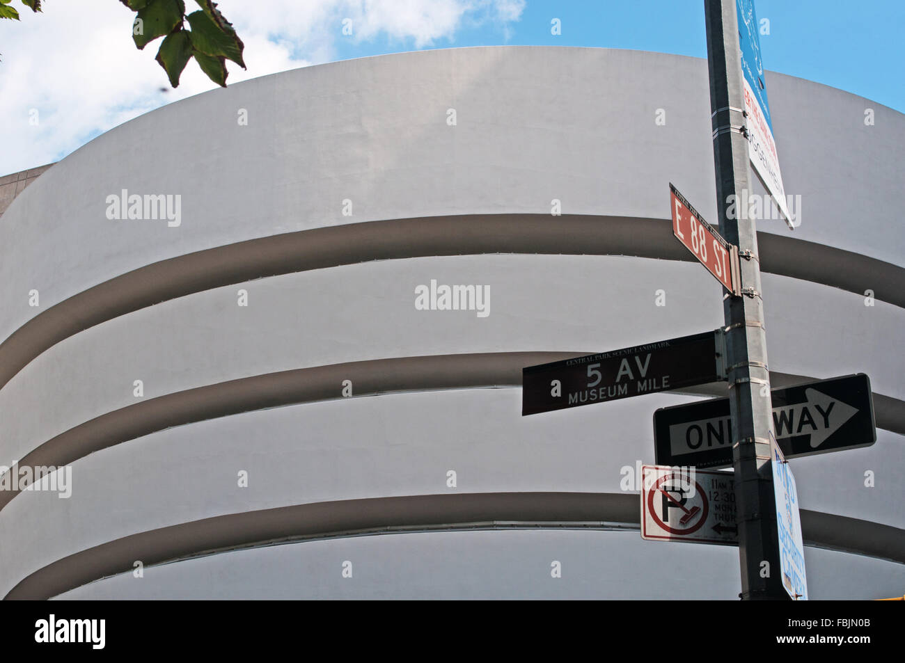 New York, United States of America: street signs and details of the Guggenheim Museum building, the iconic landmark designed by Frank Lloyd Wright Stock Photo