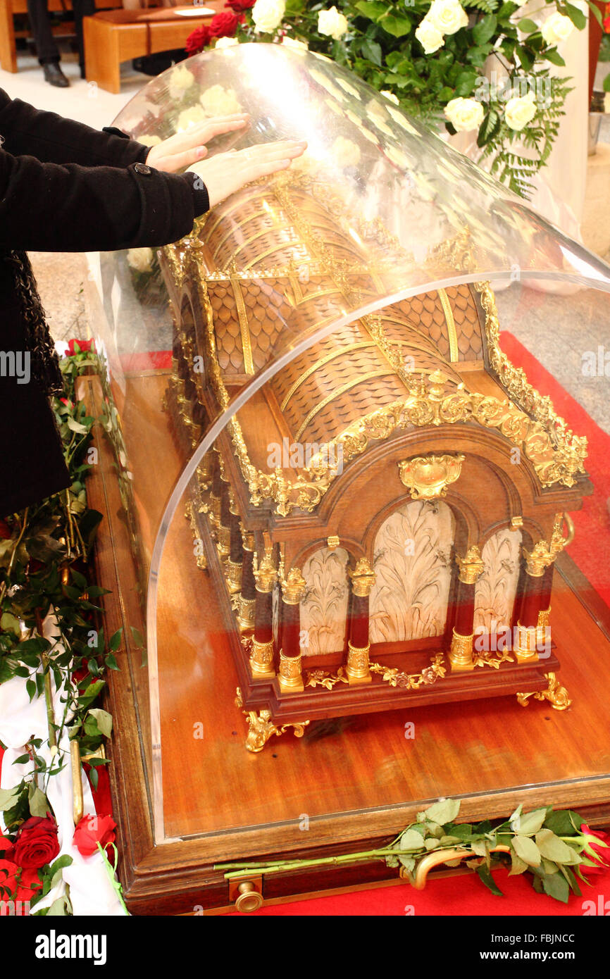 Worshipers place hands on the relics of St. Therese of Lisieux at Lady ...