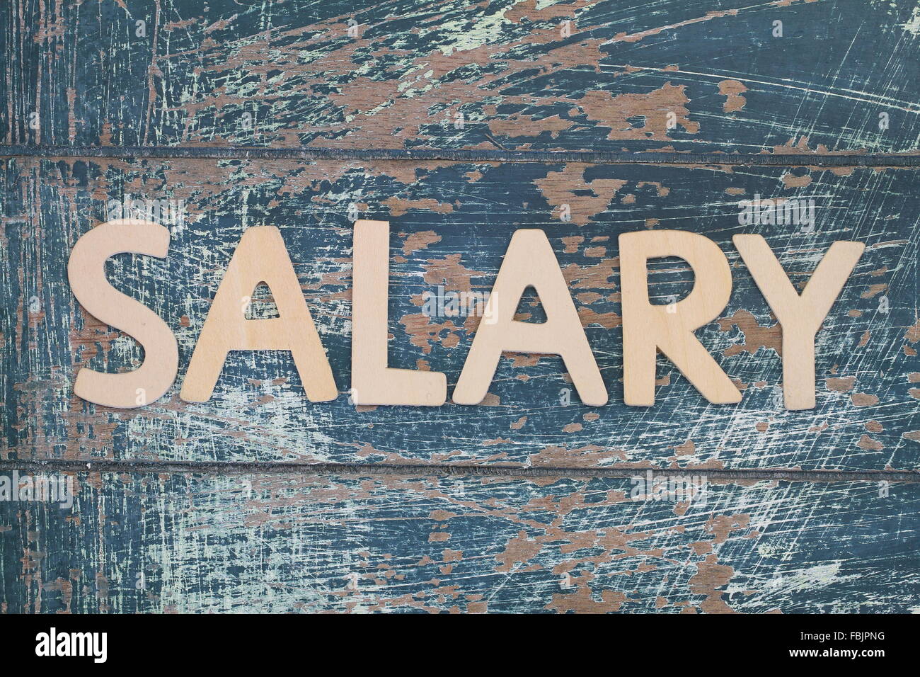 Word salary written with wooden letters on rustic surface Stock Photo