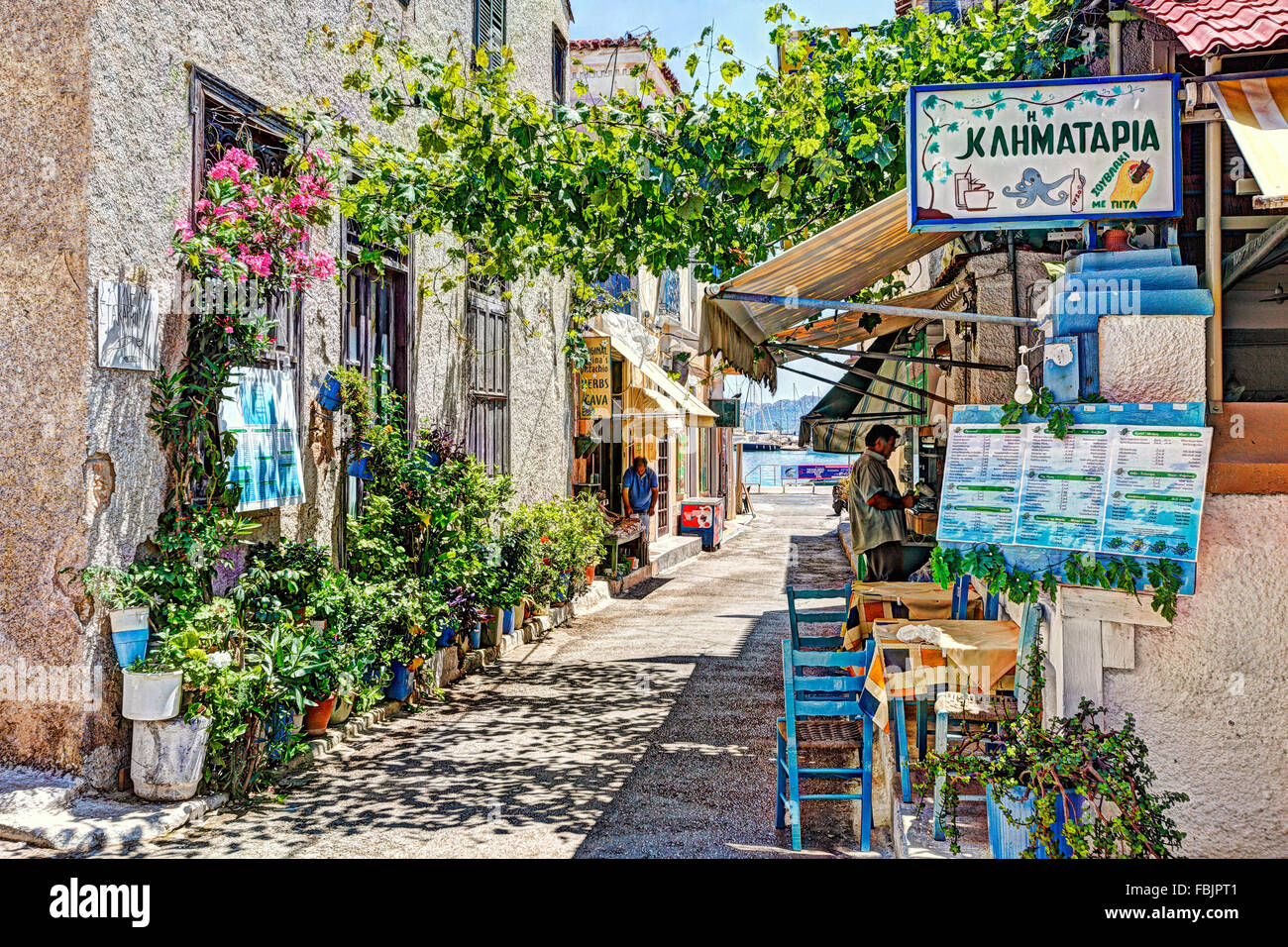 Traditional Greek tavern in the port of Aegina island, Greece Stock Photo