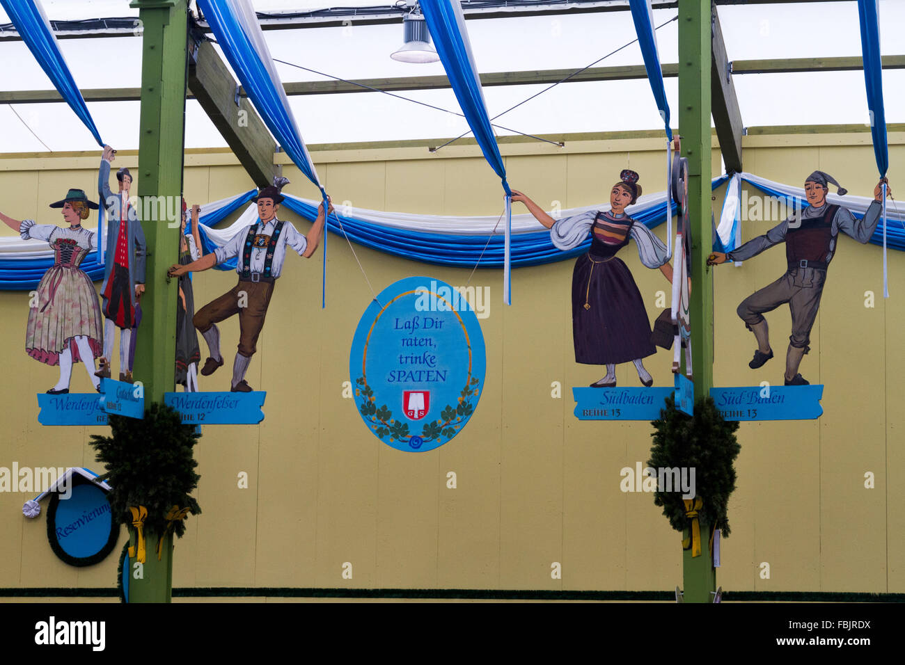 Decorative dancing figures hanging in a beer tent at Oktoberfest in Munich, Germany. Stock Photo