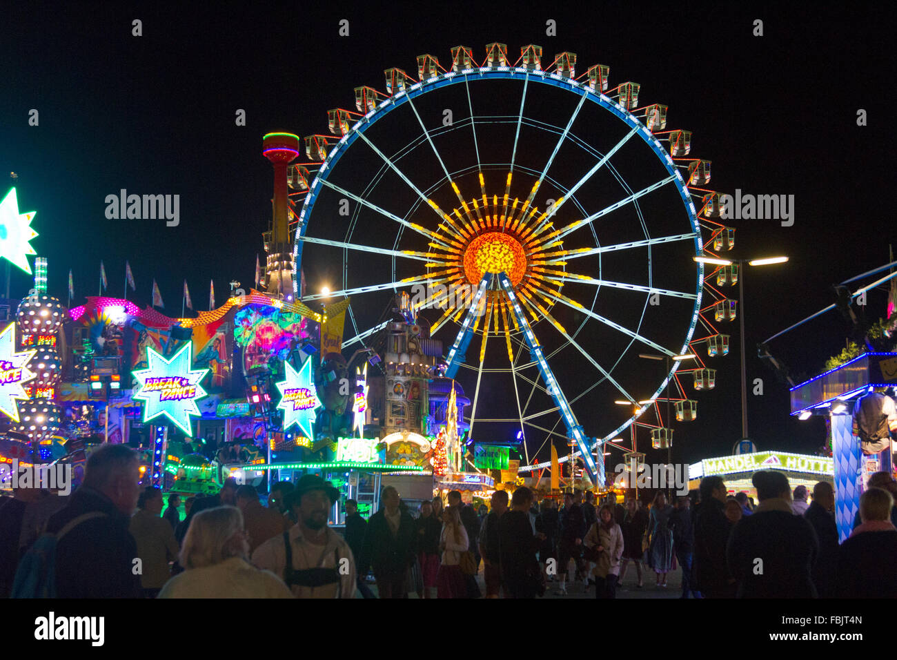 Brightly lit ferris wheel at night as part of Oktoberfest carnival in ...