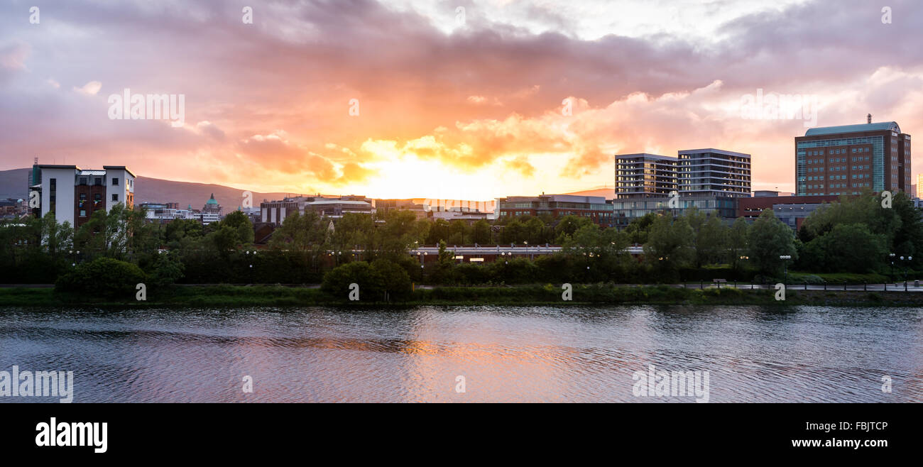 The evening sun sets over Belfast city centre skyline. Stock Photo