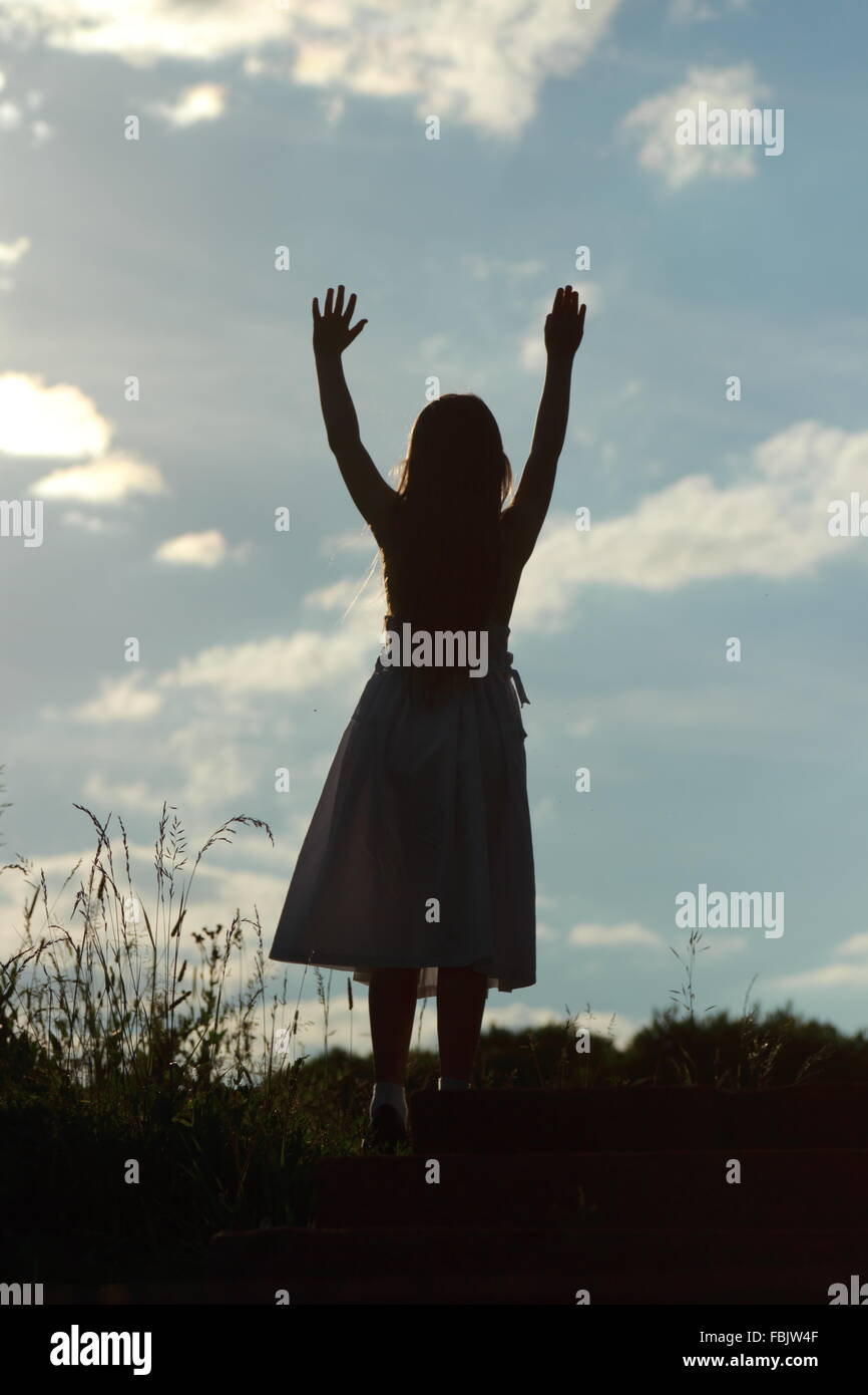 Silhouette of of a little girl on nature background at sunset Stock ...