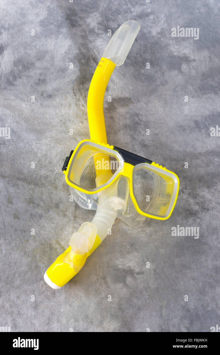 yellow snorkel and mask gear isolated against gray background Stock