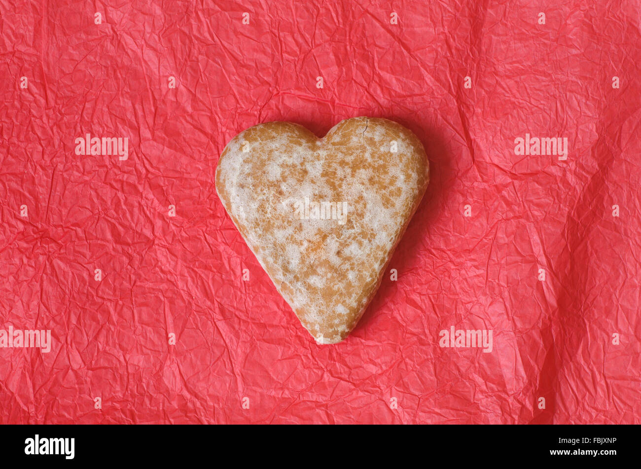 gingerbread heart cookie on red paper table background Stock Photo - Alamy