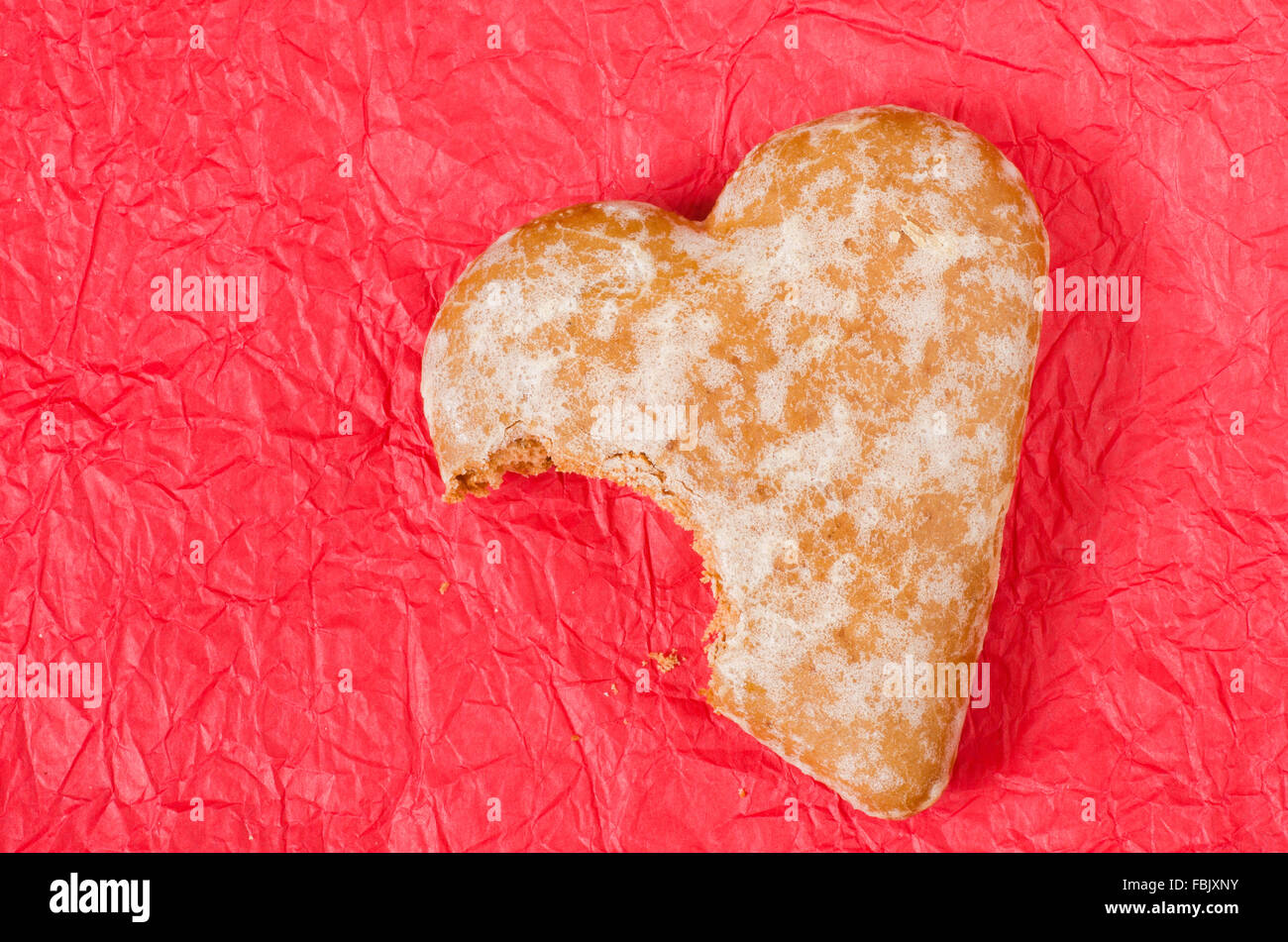 gingerbread heart cookie on red paper table background Stock Photo - Alamy