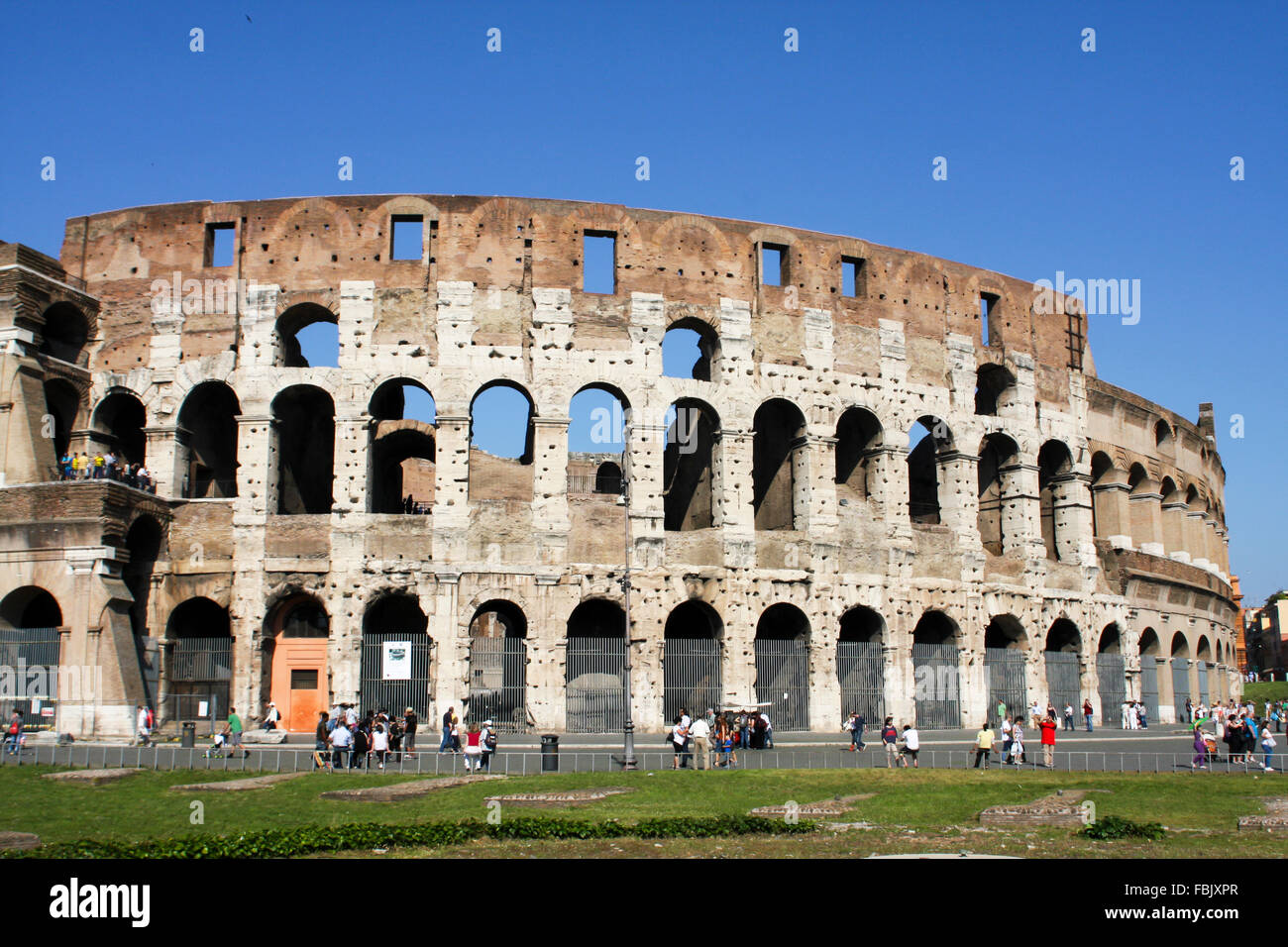 ROME, ITALY- JUNE 2, 2012: Unidentified people by Colloseum in Rome, Italy. It is most remarkable landmark of Rome and Italy. Th Stock Photo