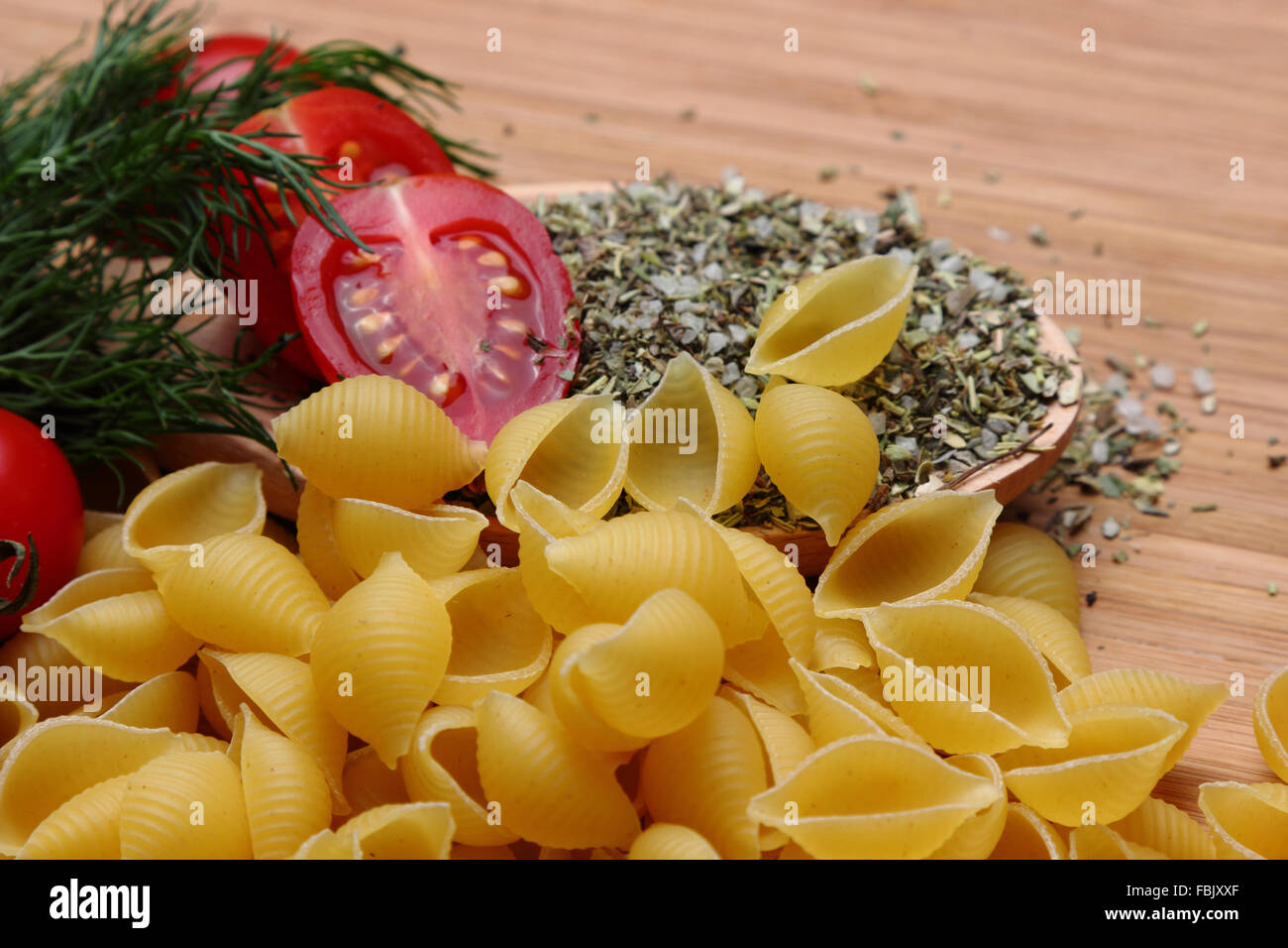 Raw pasta with tomatoes Stock Photo