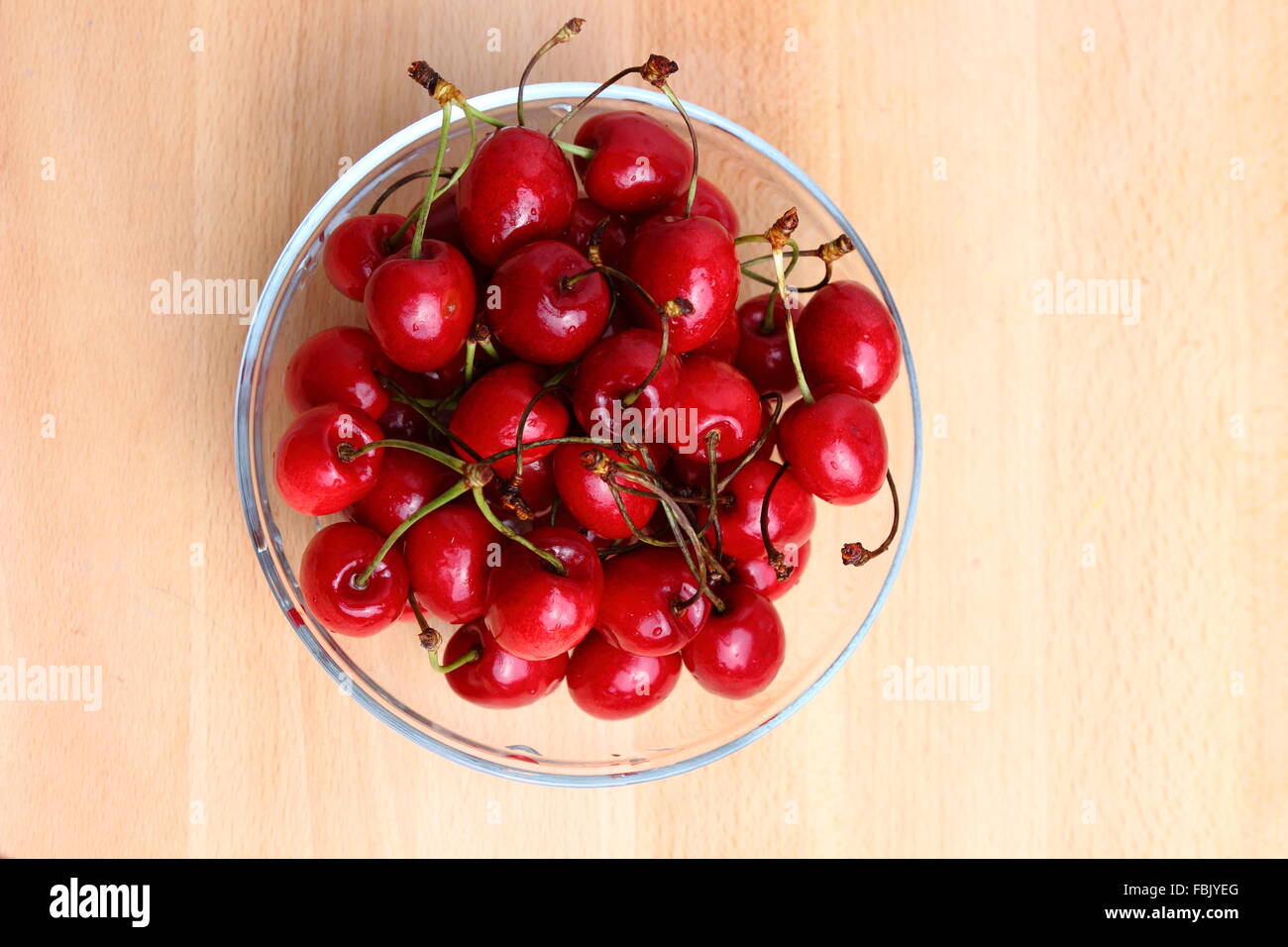 Organic ripe cherries in a glass bowl Stock Photo
