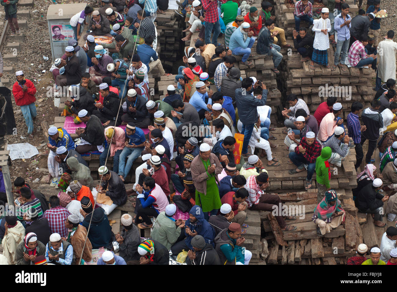 DHAKA, BANGLADESH 10th January 2016: Bangladeshi Muslim devotees attend the Akheri Munajat concluding prayers on the third day of Biswa Ijtema, the second largest Muslim congregation after the Hajj, at Tongi Railway station in Tongi 20 km from Dhaka on January 10, 2016. Around two million Muslims from Bangladesh and abroad observed the three-day congregation with prayers on the banks of the Turag River. Stock Photo