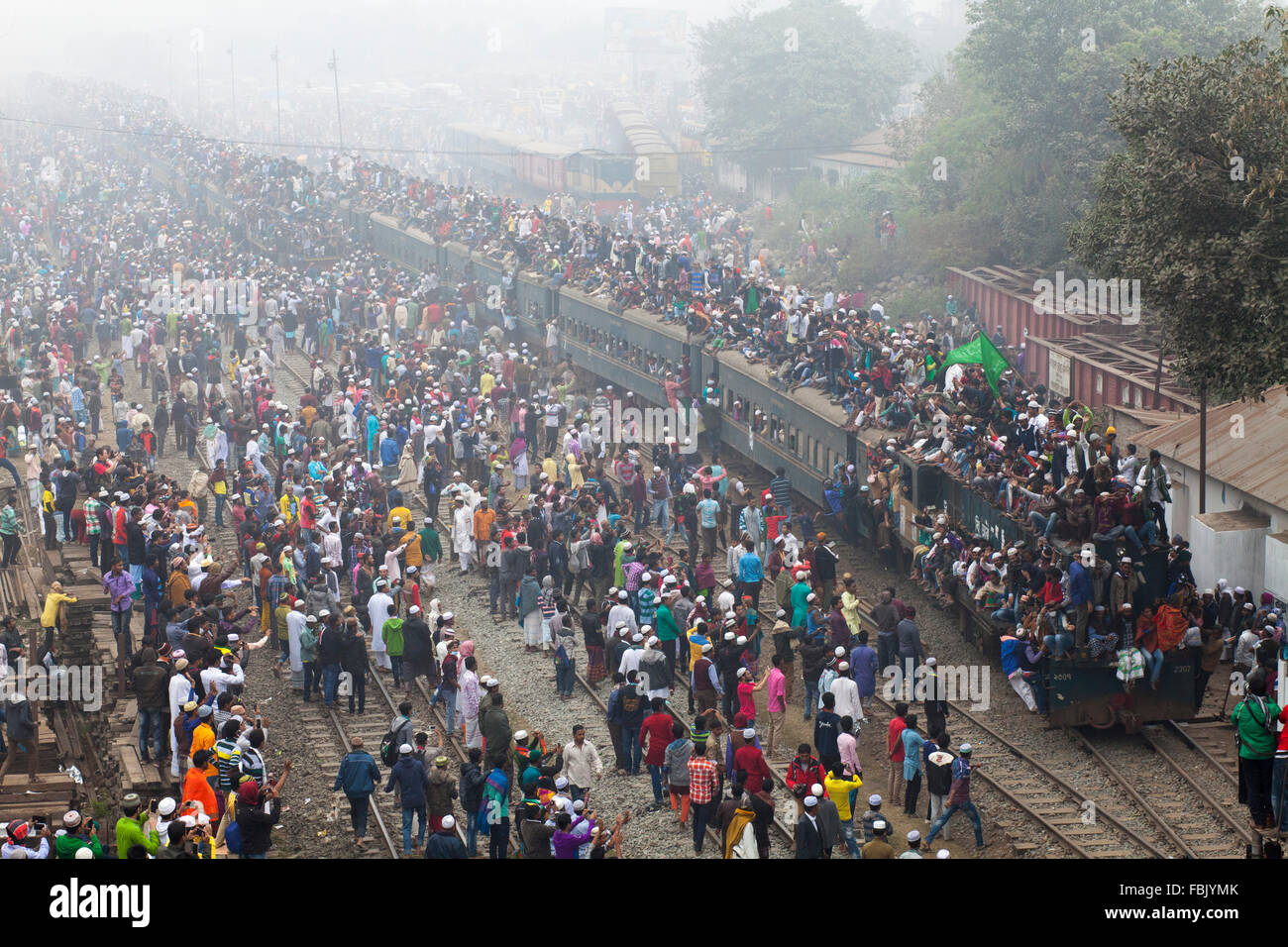 DHAKA, BANGLADESH 10th January 2016:Bangladeshi Muslim devotees board trains after attending the Akheri Munajat concluding prayers on the third day of Biswa Ijtema, the second largest Muslim congregation after the Hajj, at Tongi Railway station in Tongi 20 km from Dhaka on January 10, 2016. Around two million Muslims from Bangladesh and abroad observed the three-day congregation with prayers on the banks of the Turag River. Stock Photo