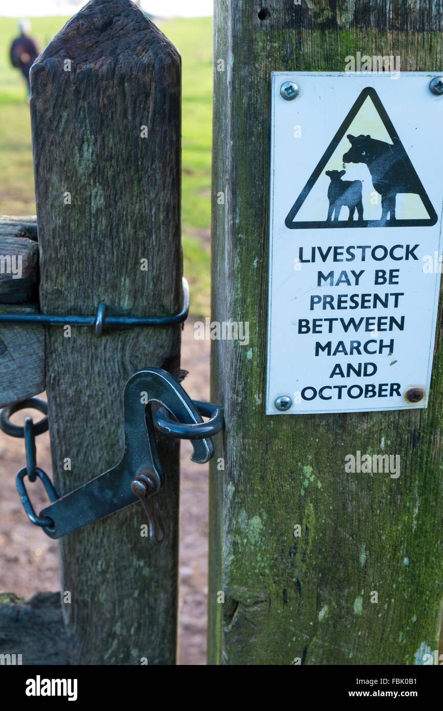 Farm gate with latch and livestock warning sign. Stock Photo
