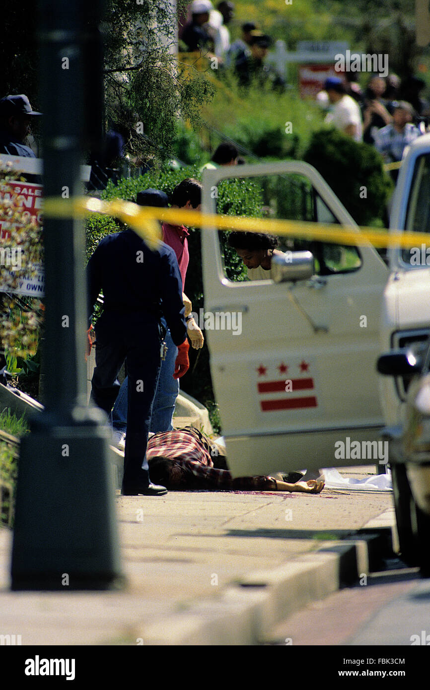 Washington, DC., USA, 1989 A shooting victim lays dead on sidewalk drug related. Credit Mark