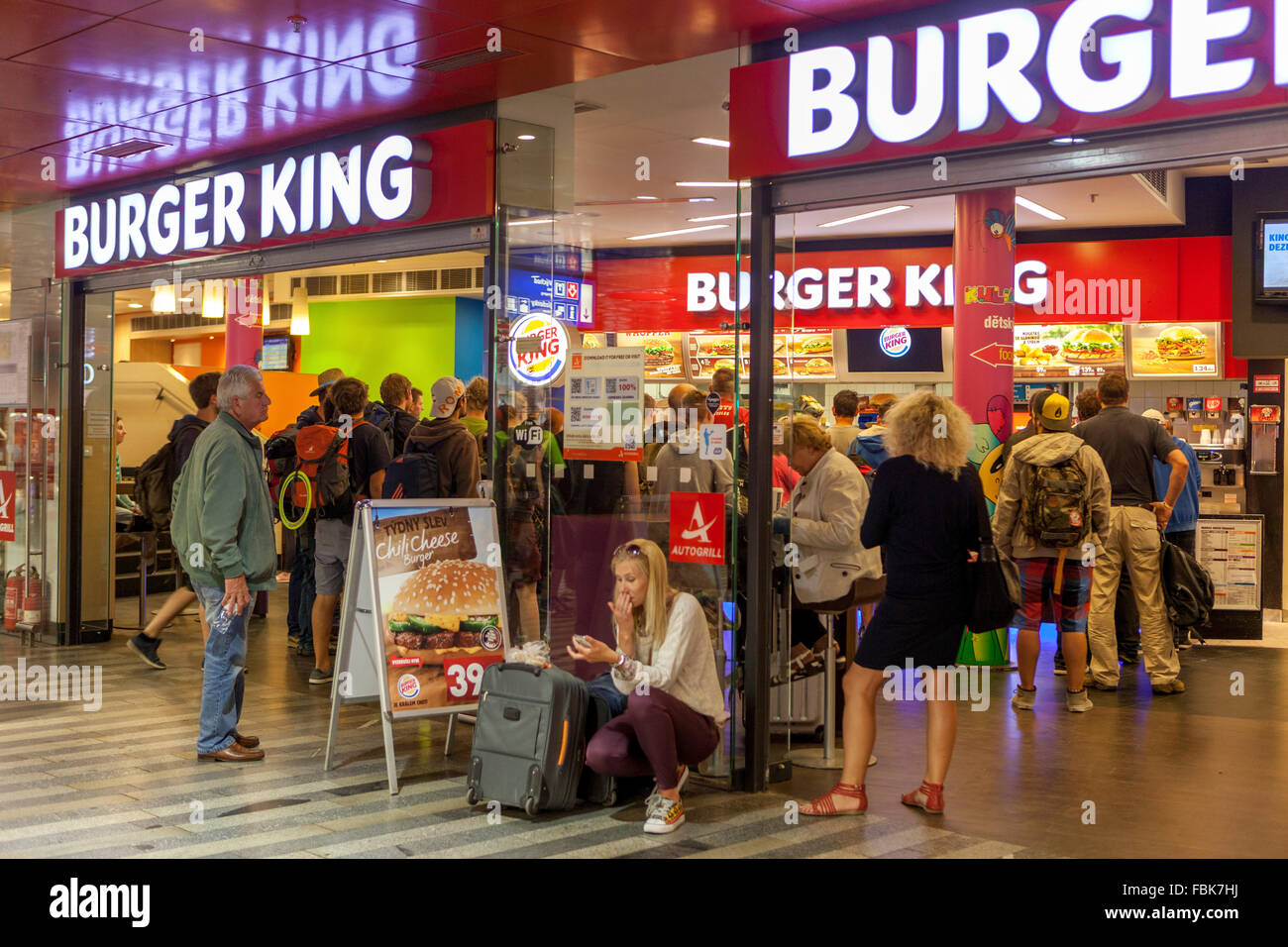 People in Burger King store front, train railway Station Prague Czech Republic Stock Photo