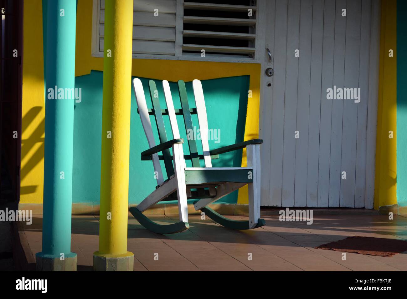 empty rocking chair on a colorful sunny veranda in Vinales, Pinar Del Rio Province, Cuba Stock Photo
