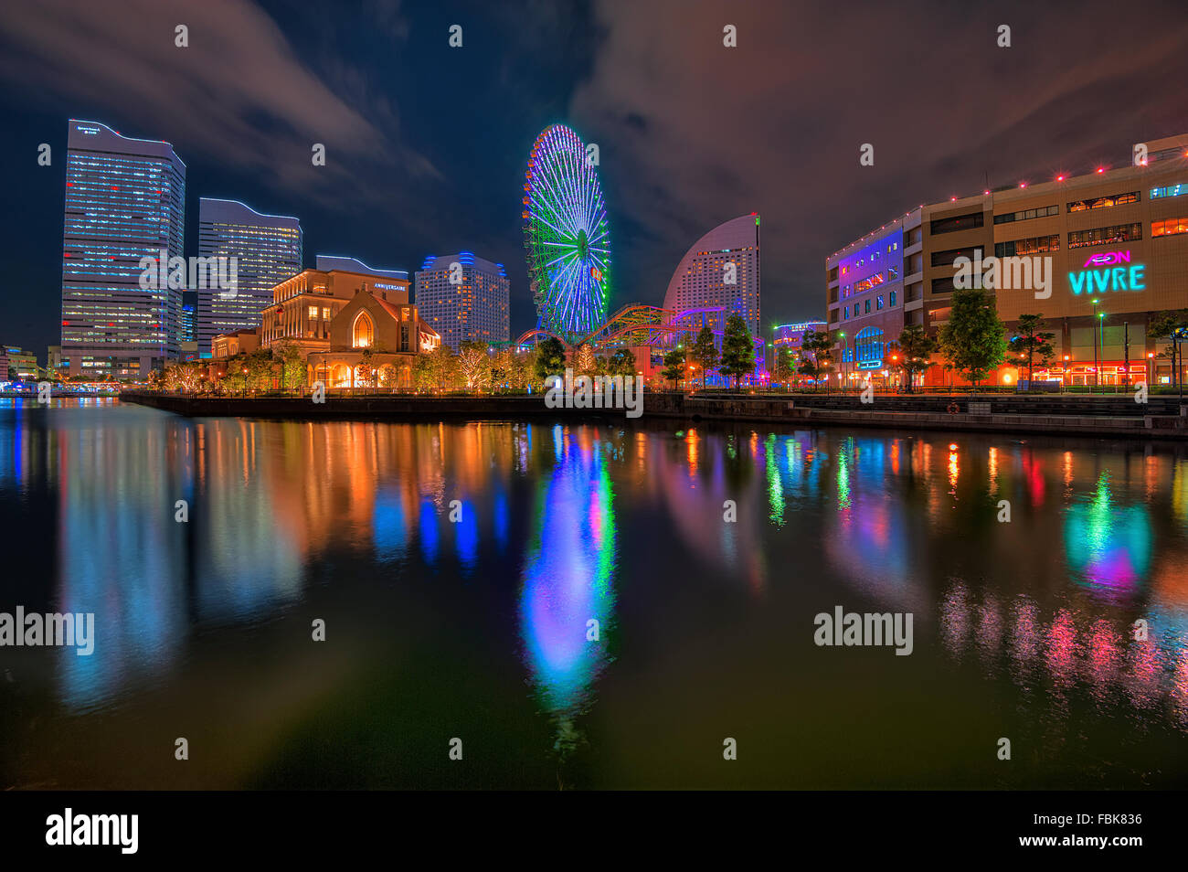 The reflection of of the modern buildings over the river in Yokohama central business district during night. Stock Photo