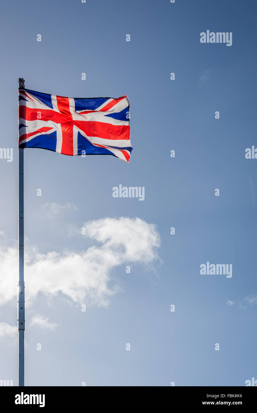 Union Jack flag on United Kingdom flies from white pole in Belfast Stock Photo