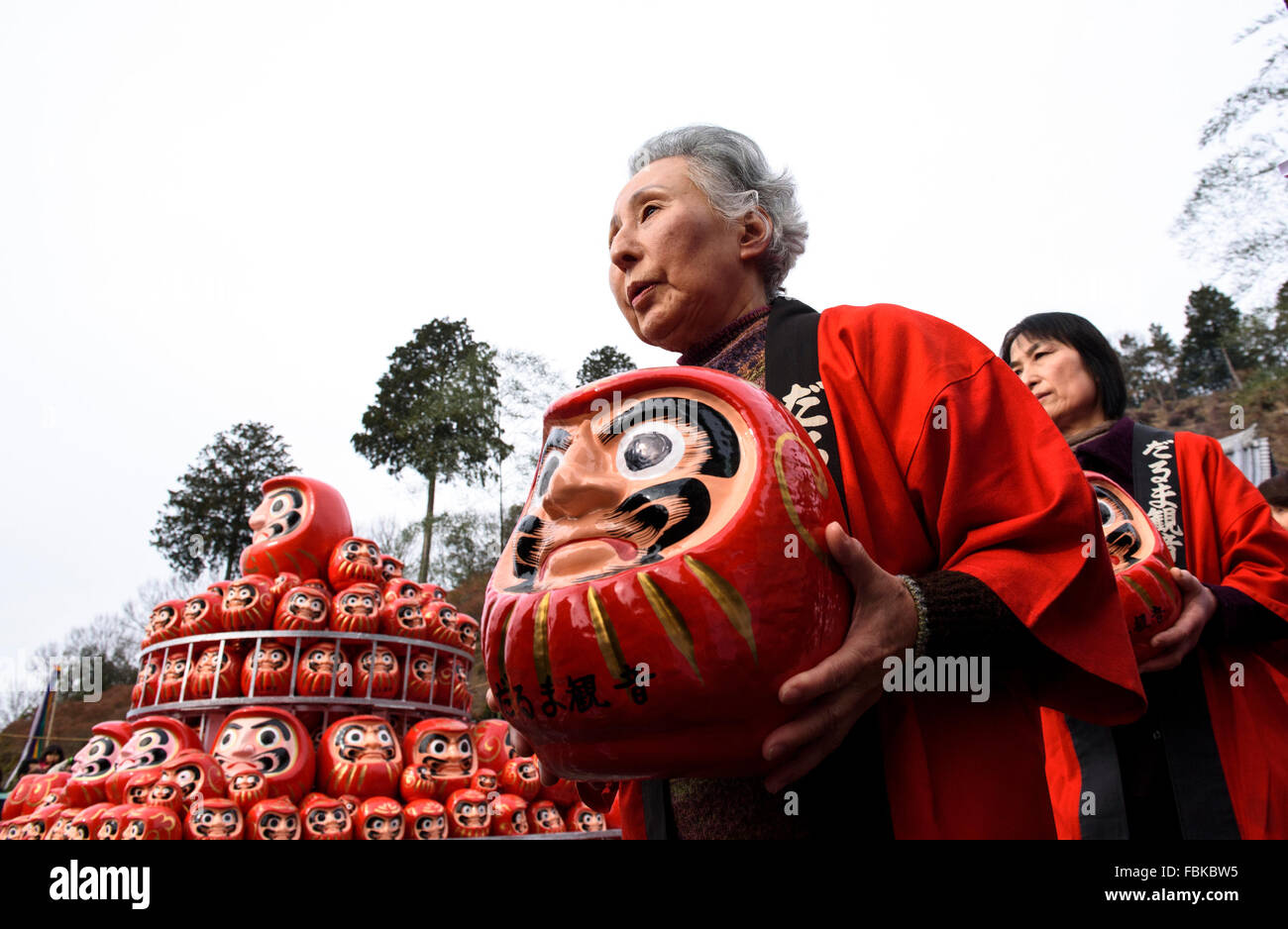 Gifu, Japan. 17th Jan, 2016. Buddhists carry dolls at the start of the