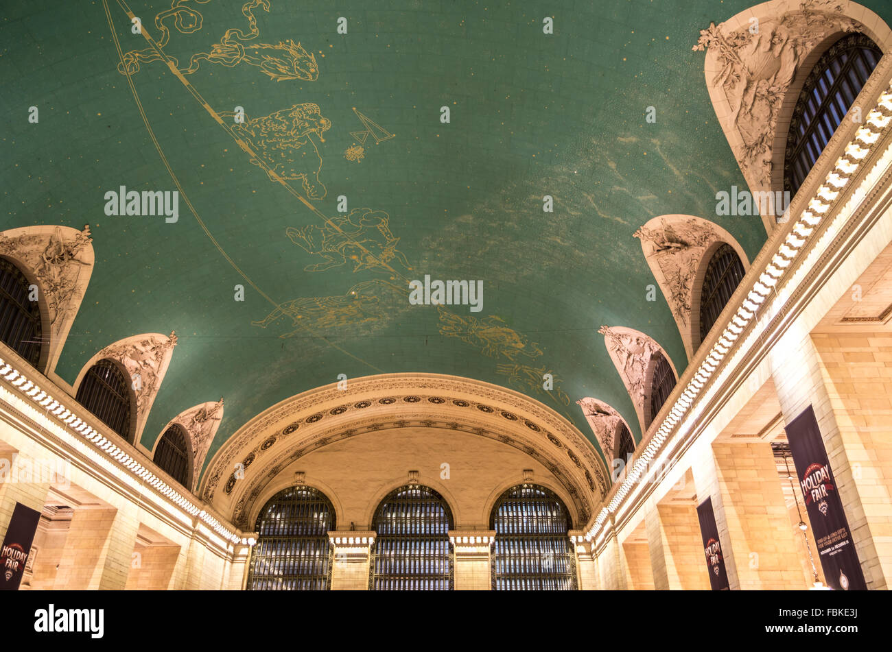 View of the green ceiling of the main concourse of Grand Central Terminal with an astronomical themed mural in gold. Stock Photo