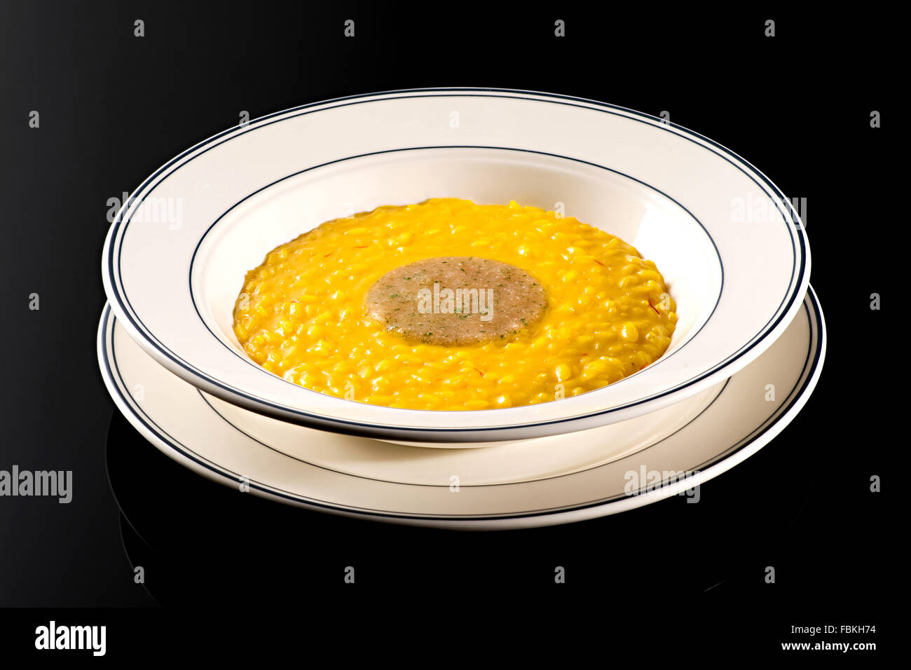 Yellow Rissotto Dish of Italian risotto with marrow colored with yellow saffron as a ...