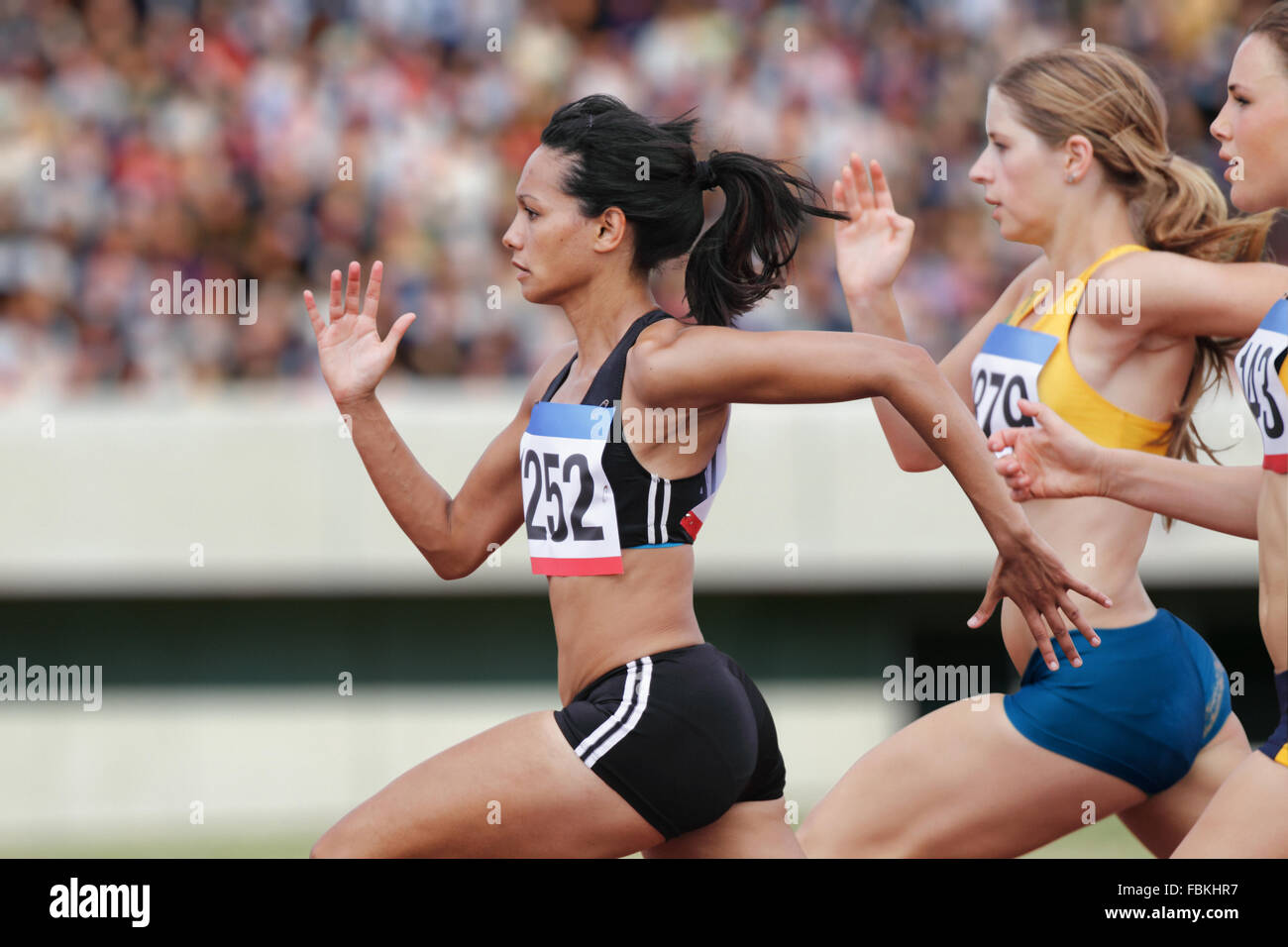 Athletes running on running track Stock Photo