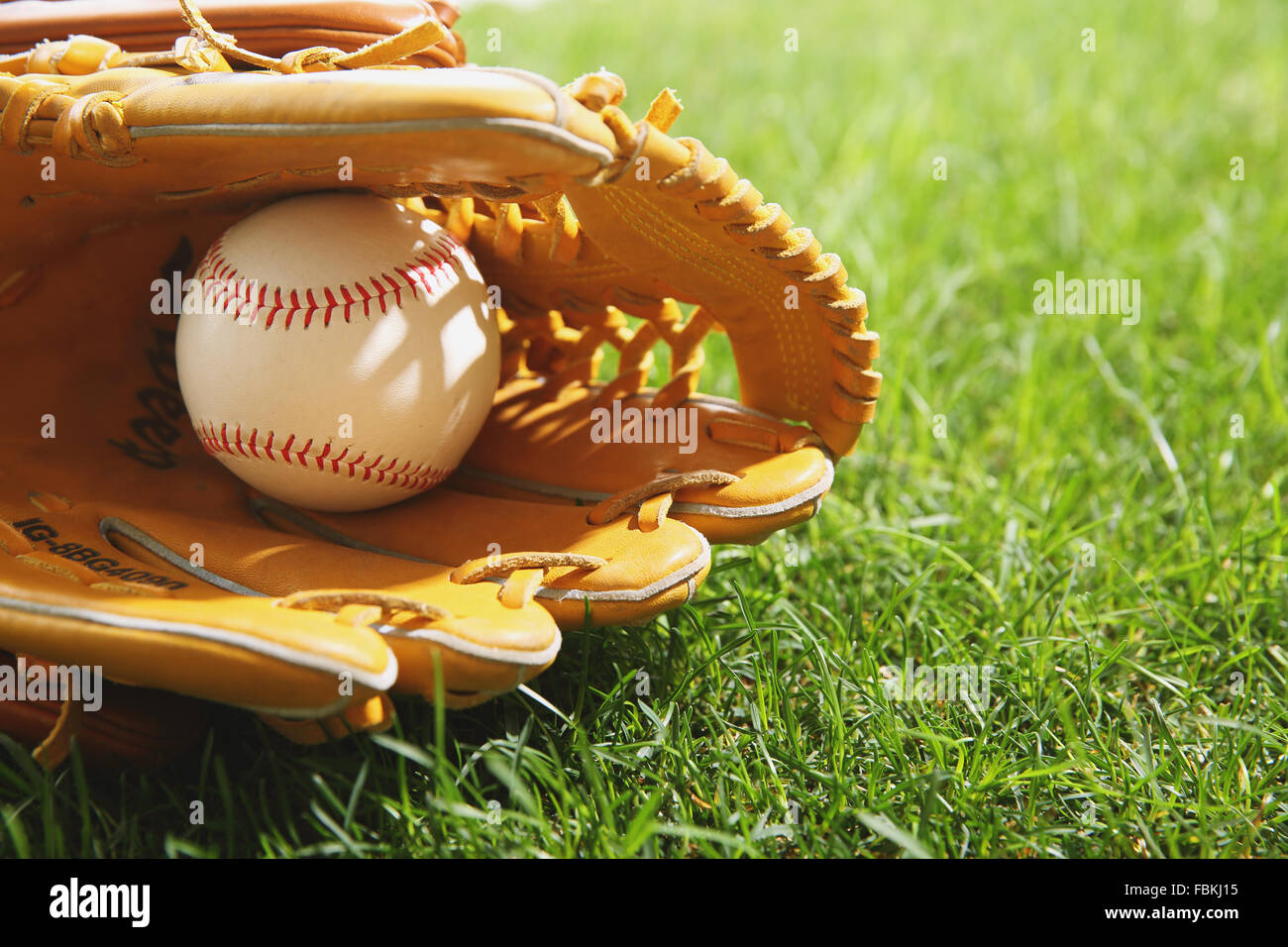 Baseball equipment on grass Stock Photo - Alamy