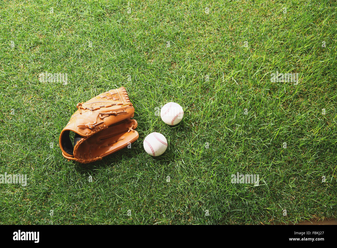 Baseball equipment on lawn hi-res stock photography and images - Alamy