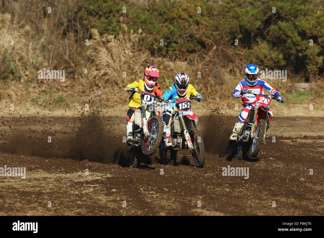 Motocross bikers on dirt track Stock Photo