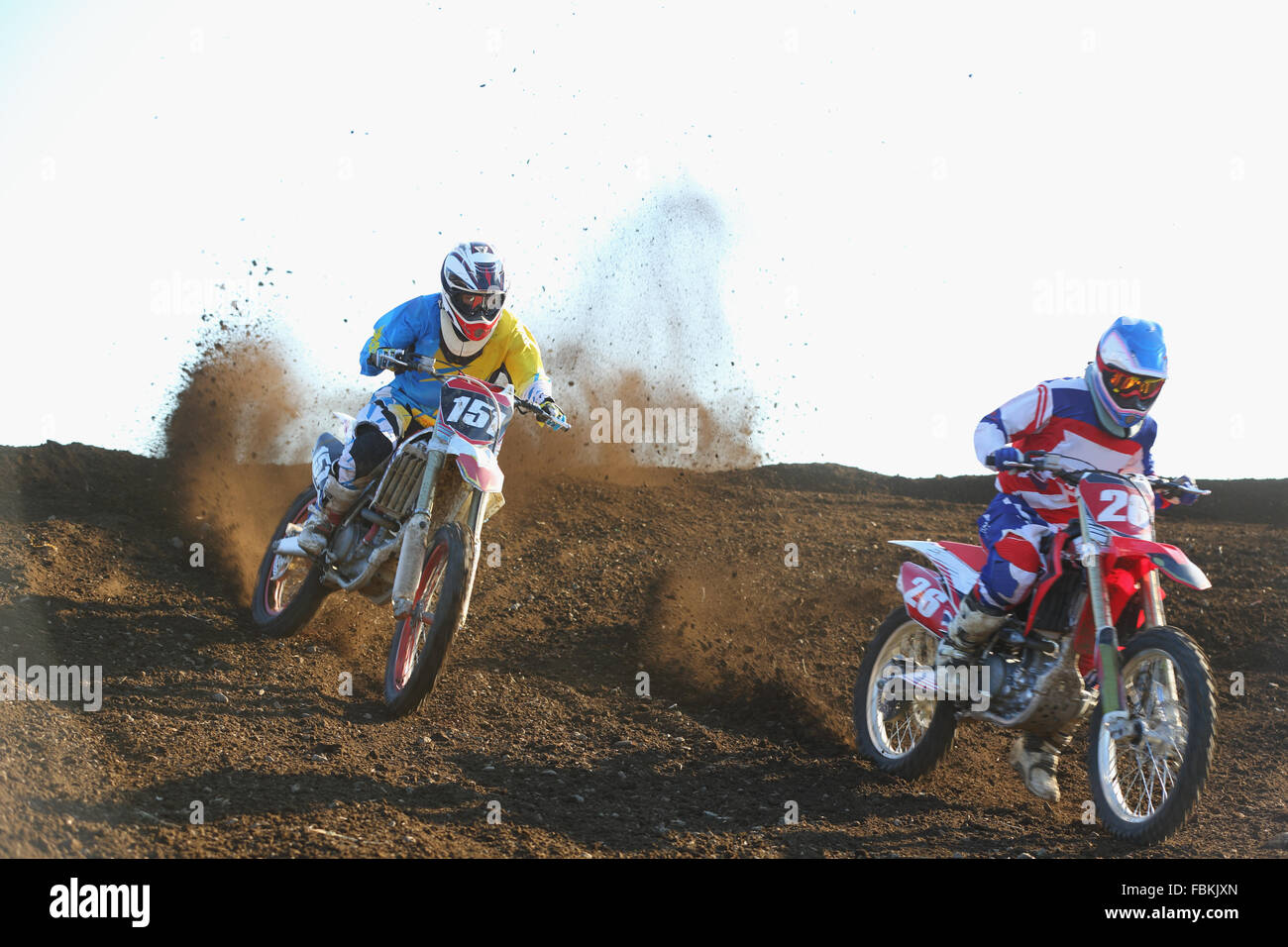 Motocross bikers on dirt track Stock Photo