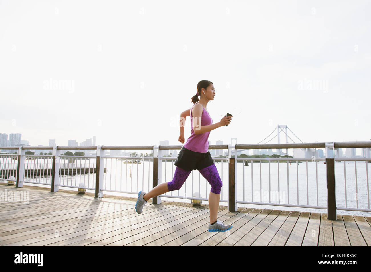 Young Japanese woman running downtown Tokyo Stock Photo Alamy