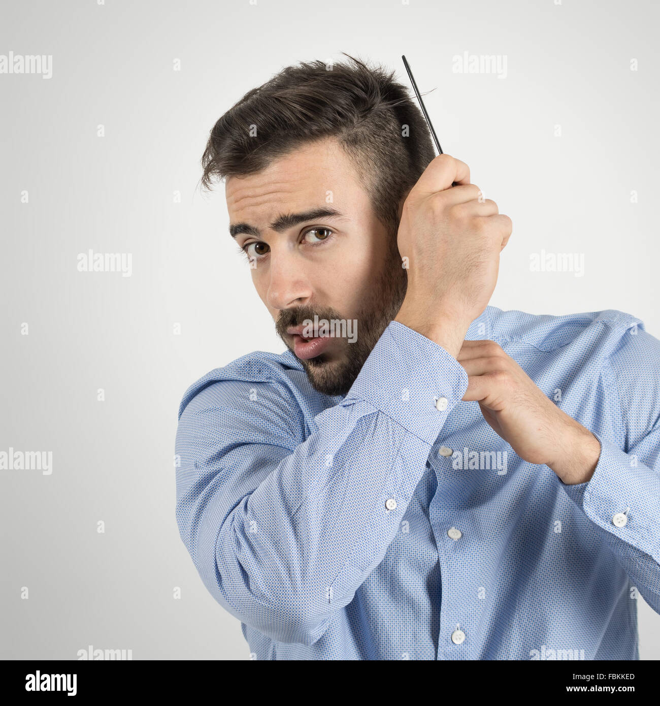 Concentrated Focused Young Man Coming Hair To Achieve Hairstyle