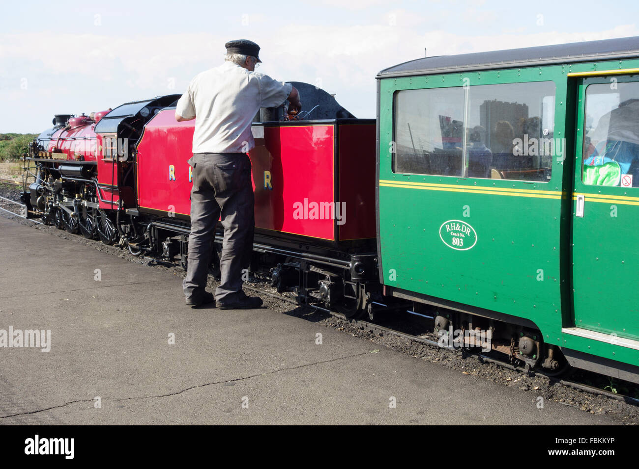 England, Kent, Dungeness. An engineer checks the water levels in the minature steam locomotive, 'Winston Churchill' Stock Photo