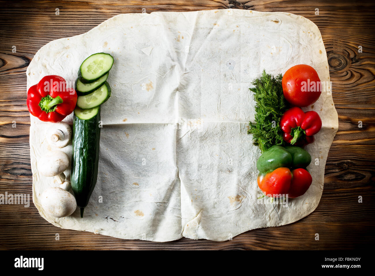 vegetables on pita on the wooden background. Stock Photo