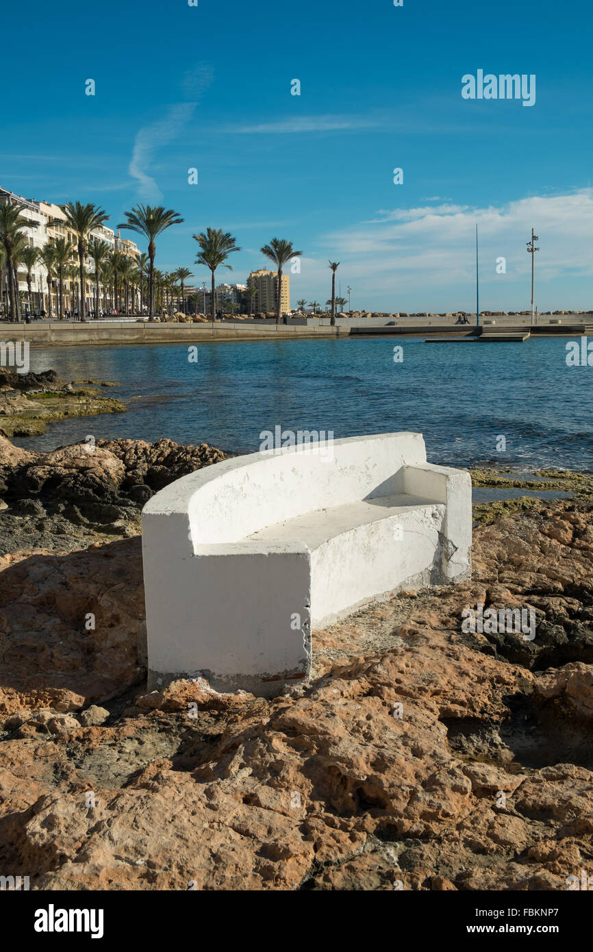Stone benches on scenic Torrevieja  beach, Costa Blanca, Spain Stock Photo